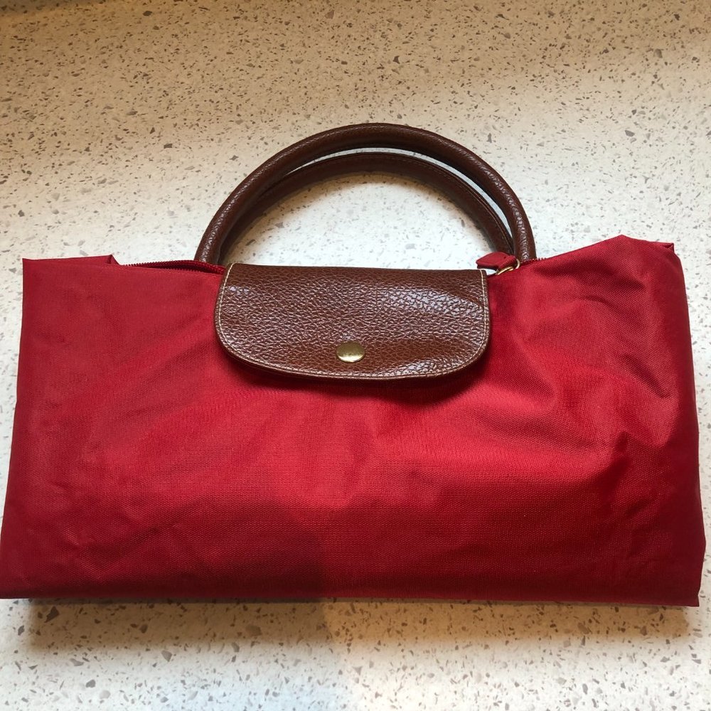 Very large tote, folds compact for easy travel, reinforced nylon, leather trim